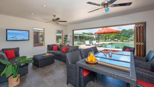 a living room filled with furniture and a swimming pool at Reign Manor and Coach House in Worragee