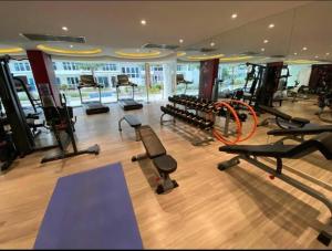 un gimnasio con una fila de cintas de correr y máquinas en Large Deluxe Condo Grand Avenue Central Pattaya en Pattaya centro