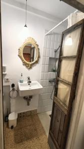 a bathroom with a sink and a mirror at Casa James in Vejer de la Frontera