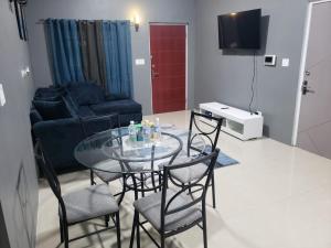 a glass table and chairs in a living room at victory Luxury Suites in Montego Bay