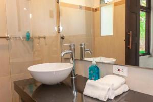 a bathroom with a sink and a mirror and a sink at La Maima in Dapa