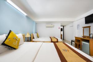 a hotel room with a bed and a desk at Janus Hotel 168 in Ho Chi Minh City