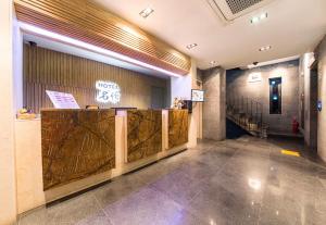 a lobby of a building with a sign on the wall at HOTEL MYEONG JAK in Suwon