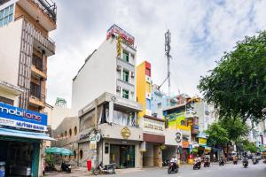 a building on a street in a city at Janus Hotel 168 in Ho Chi Minh City