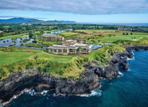 an aerial view of a house on a cliff next to the ocean at Timbers Kaua'i in Lihue