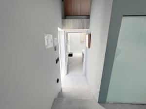 un pasillo en una casa con paredes blancas y una puerta en CASA NOBILE APARTMENTS, en La Valeta