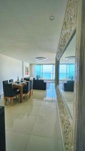 a dining room and living room with a table and chairs at Cartagena Seaview Elegance in Cartagena de Indias