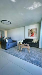 a living room with a blue couch and a coffee table at Cartagena Seaview Elegance in Cartagena de Indias