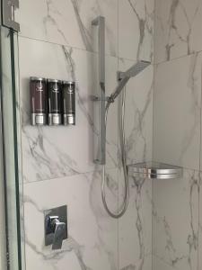 a shower in a bathroom with a glass door at Beachfront Haven in Christchurch