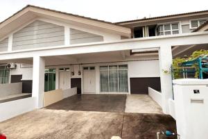 uma grande casa branca com uma entrada em Suria Villa @ 5 mins A'famosa Resort em Kampong Alor Gajah