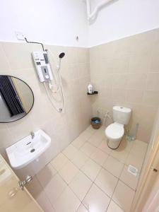 a bathroom with a shower and a toilet and a sink at Suria Villa @ 5 mins A'famosa Resort in Kampong Alor Gajah