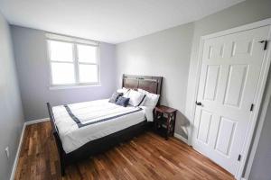 a bedroom with a bed and a window and a door at Castle in Queens Fit for Royalty in Rosedale