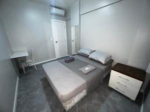 a small bedroom with a bed and a dresser at Lindo vista mar na Praia do Buracão - Rio Vermelho in Salvador