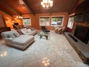 a living room with a couch and a fireplace at Serene Oasis Getaway with Sauna and a swim spa. in Portland