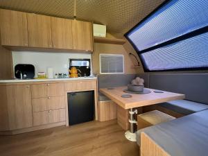 a kitchen with a table and a large window at Premium Caravan in Sapanca