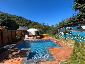 a swimming pool with a table and chairs next to a house at Premium Caravan in Sapanca