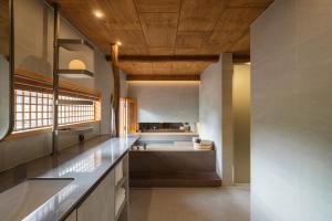 a large kitchen with a sink and a counter at Luxury hanok with private bathtub - Happyjae in Seoul