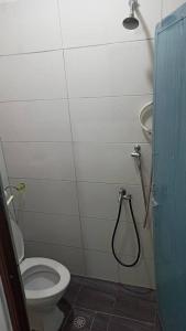 a bathroom with a toilet and a shower at TokBi Homestay Gerik in Gerik