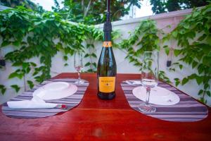 a table with a bottle of wine and two glasses at SHERON RESORT in Unawatuna