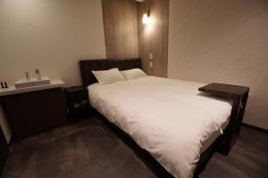 Postel nebo postele na pokoji v ubytování MARUKOU HOTEL