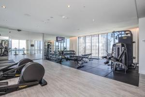 a gym with treadmills and exercise equipment in a building at Golden Horizons - Resort Living in the Clouds in Gold Coast