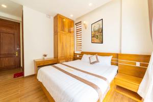 Postel nebo postele na pokoji v ubytování Ánh Phương Hotel Đà Lạt