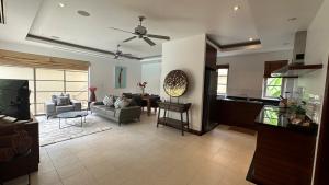 a living room with a couch and a table at The Residence Resort & Spa Retreat in Bang Tao Beach