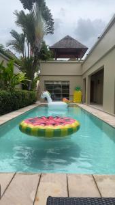 uma piscina com um brinquedo insuflável numa casa em The Residence Resort & Spa Retreat em Praia de Bang Tao