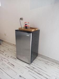 a small refrigerator with a counter on top of it at Ramona loft in Villahermosa