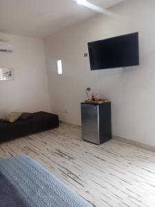 a room with a bed and a flat screen tv on the wall at Ramona loft in Villahermosa