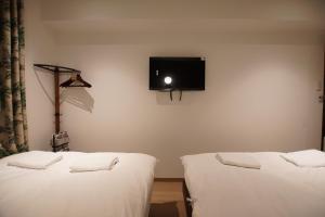 Postel nebo postele na pokoji v ubytování MARUKOU HOTEL