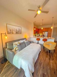 a bedroom with a large bed and a kitchen at Downtown Houston Gem: Parking Pool WiFi Sleeps 4 in Houston