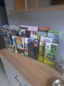a bunch of books sitting on top of a counter at Fewo Lerchi am Nürburgring in Kelberg