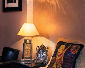 a lamp and a clock on a table next to a chair at Riad Star by Marrakech Riad in Marrakech