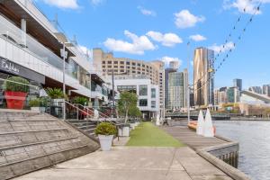 a view of a city with a river and buildings at Resort Style Living Yarra Wharf in Melbourne