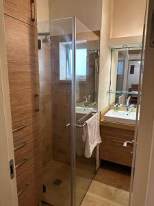 a bathroom with a glass shower and a sink at Family Park apartment with 2 bedrooms in Tel Aviv