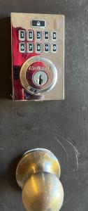 a close up of a remote control with a button at Select Luxurious 1 Room 1 king-sized Bed in Fresno Texas in Fresno