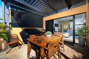 a patio with a table and chairs and a living room at Gwydir Court 1 in Forster