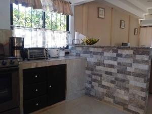 a kitchen with a brick counter top in a room at Estrella de Mar Home in Jobos