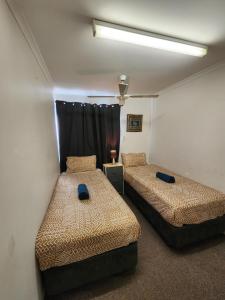 a room with two beds and a window at Perth City Apartment Hotel in Perth