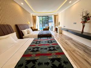 a hotel room with two beds and a rug on the floor at Lake View Resort in Pokhara
