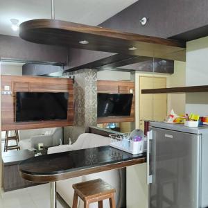 a kitchen with a black counter top in a room at Apartemen Educity Pakuwon city Surabaya BACA DESKRIPSI DULU in Surabaya +21 photos