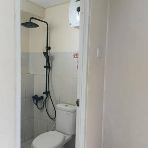 a bathroom with a toilet and a shower in it at Apartemen Educity Pakuwon city Surabaya BACA DESKRIPSI DULU in Surabaya