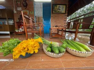 three baskets of vegetables sitting on a table at Vong Nguyet Homestay - Entire Bungalow 36m2 in Tây Ninh +26 photos