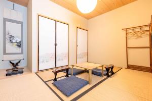 a room with a table and some windows at Uji Cha-gan-ju-tei House in Uji