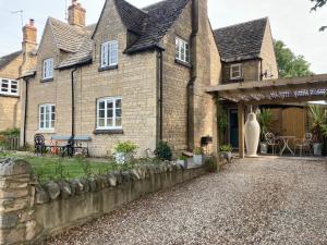 an old brick house with a stone driveway at Town and country in Stamford