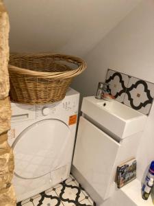 a laundry room with a washing machine and a basket on top at Town and country in Stamford