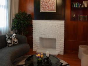 a living room with a white brick fireplace at Blu Hotel Boutique in Lima