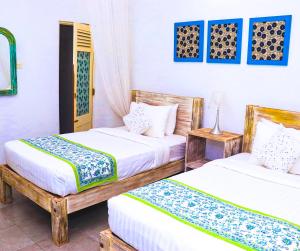 Postel nebo postele na pokoji v ubytování Esperanza Beach Mawella