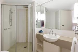 a white bathroom with a sink and a shower at Club Wyndham Coffs Harbour Terraces in Coffs Harbour +37 photos
